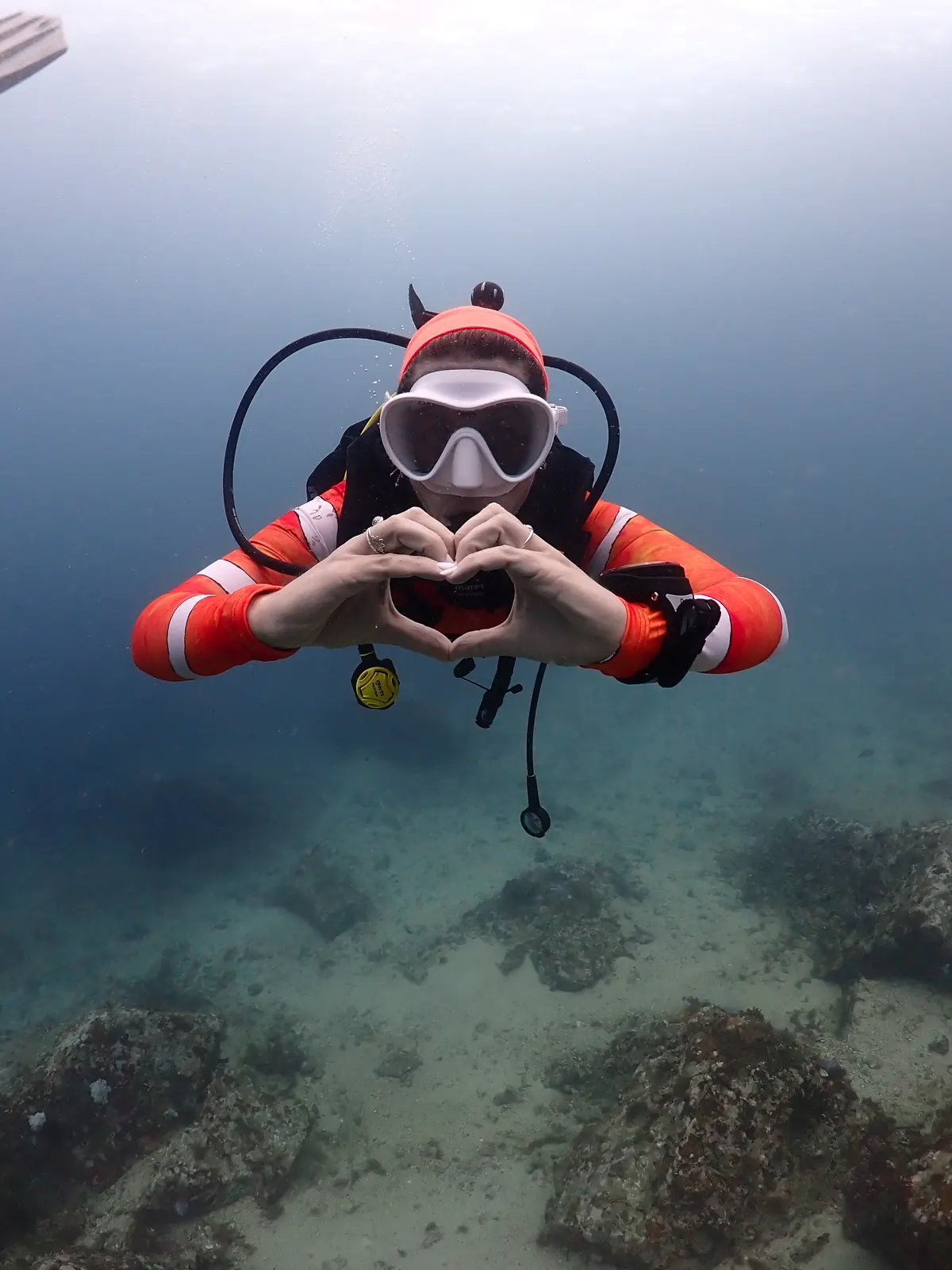Dive Master candidate making a heart sign underwater in Koh Lipe