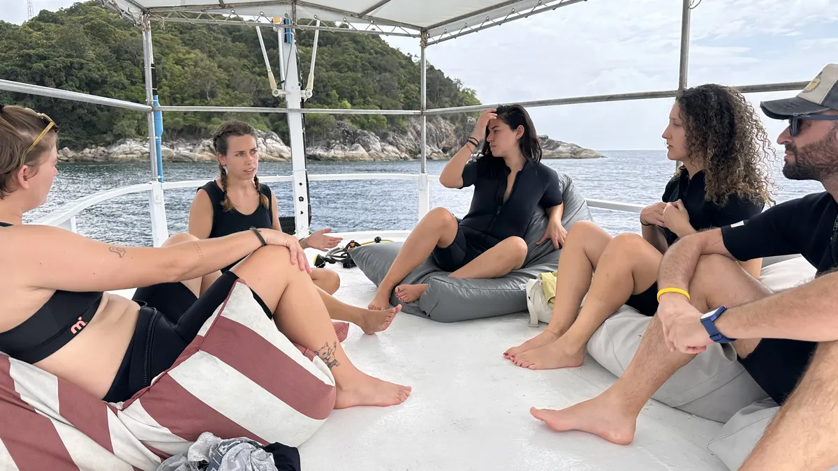 Divers chatting on the boat deck during the surface interval