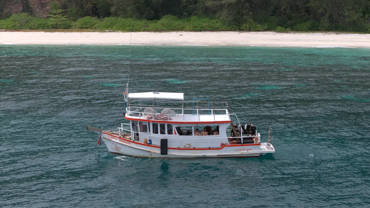 The La Bombona Diving boat from above in the clear waters off Koh Lipe