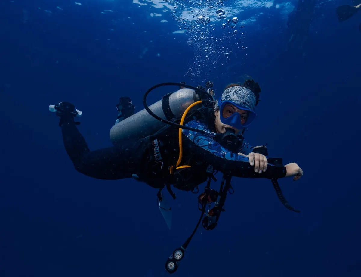 Diver hovering perfectly trimmed in the blue during the buoyancy dive