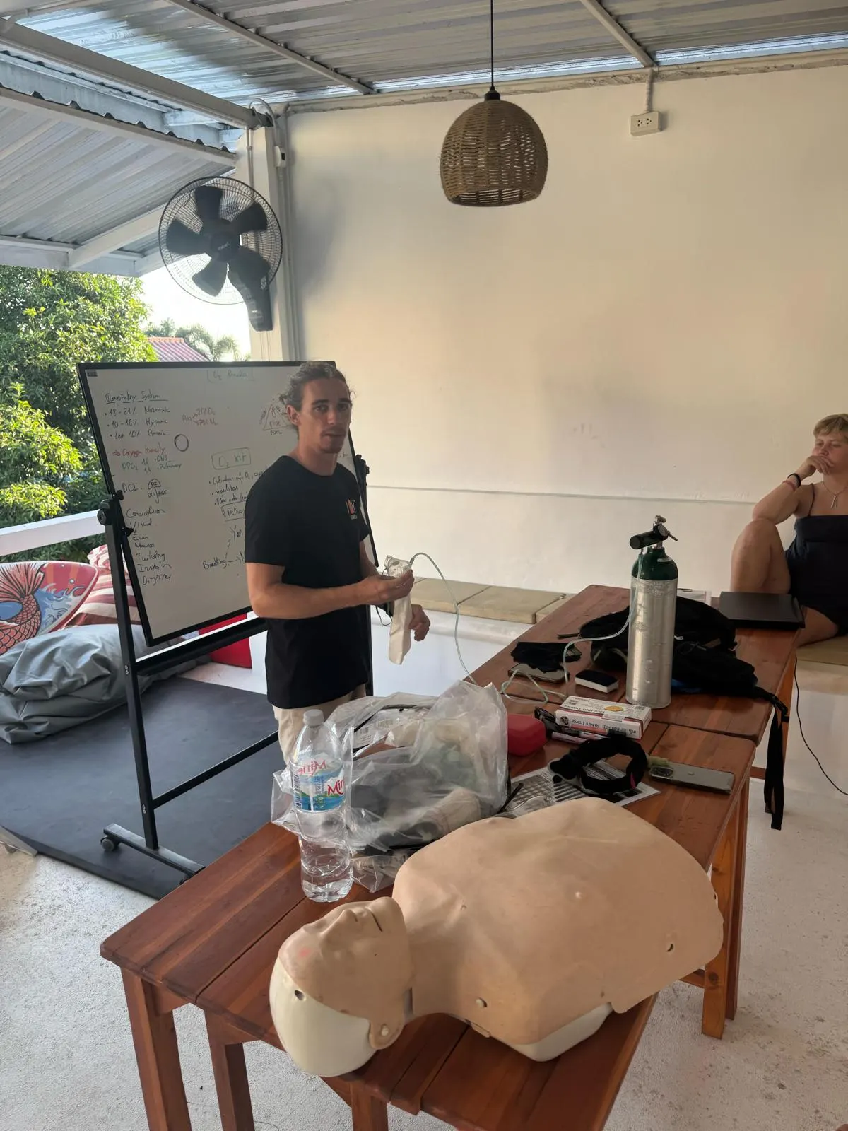 Instructor teaching First Aid & O2 theory with the CPR manikin and oxygen kit