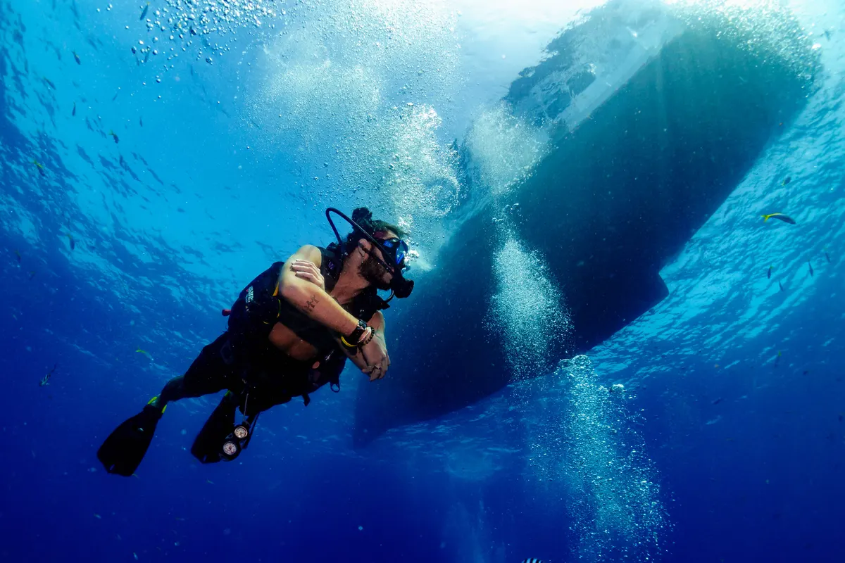 Diver descending beneath the boat for the fun dive