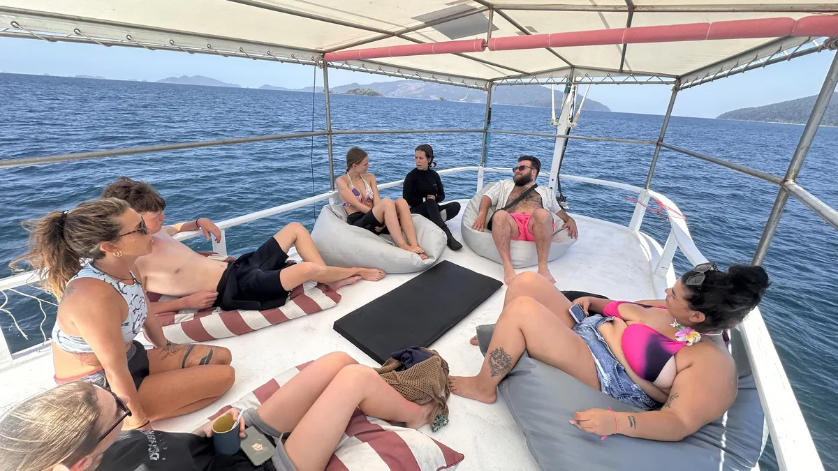 Divers relaxing on the boat rooftop on the way to the dive site