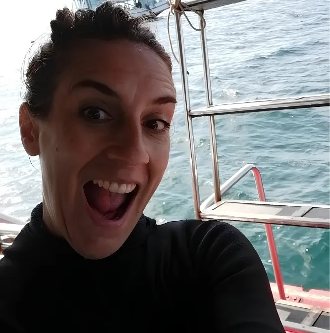 Rocío grinning on the dive boat out at sea