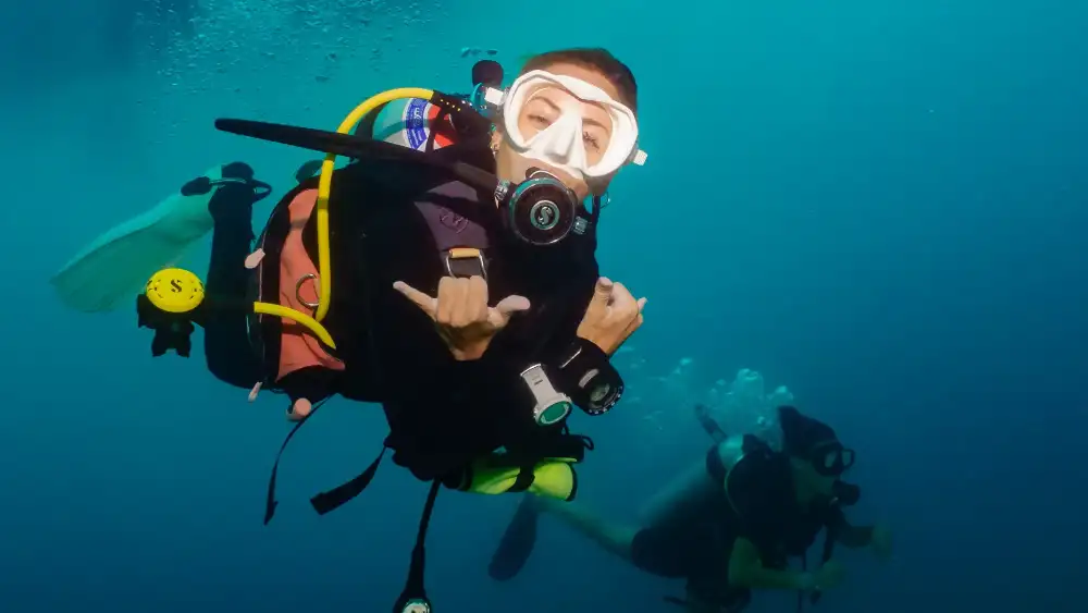 Chumphon Pinnacle dive site, Koh Tao — the granite pinnacle surrounded by schooling fish in blue water