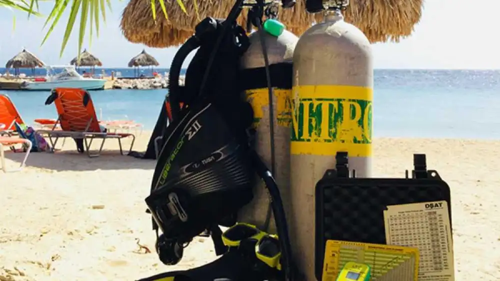 A diver breathing enriched air nitrox drifting over a coral reef in Koh Tao