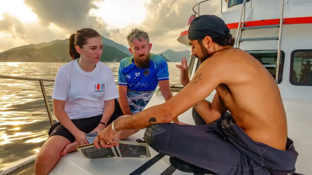 An instructor running a rescue scenario with a simulated unresponsive diver at a Koh Tao dive site