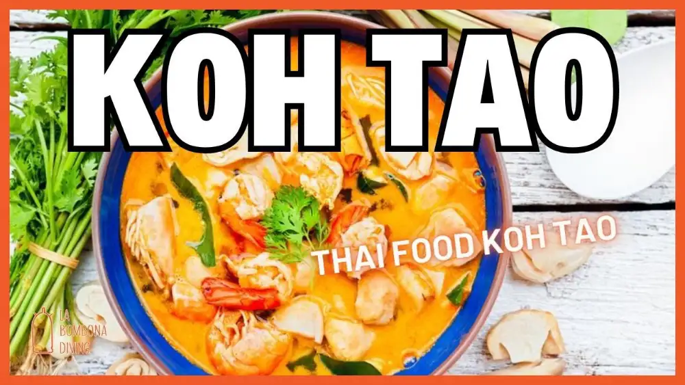 A spread of Thai dishes on a table on Koh Tao — curry, stir-fried noodles, papaya salad and steamed rice