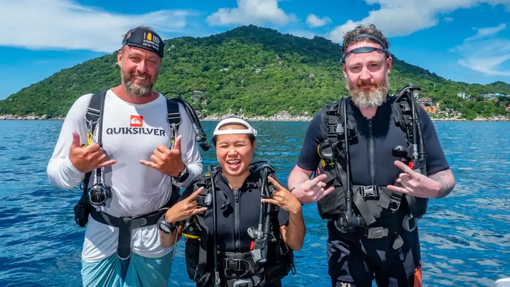 A scuba instructor teaching students skills in shallow water